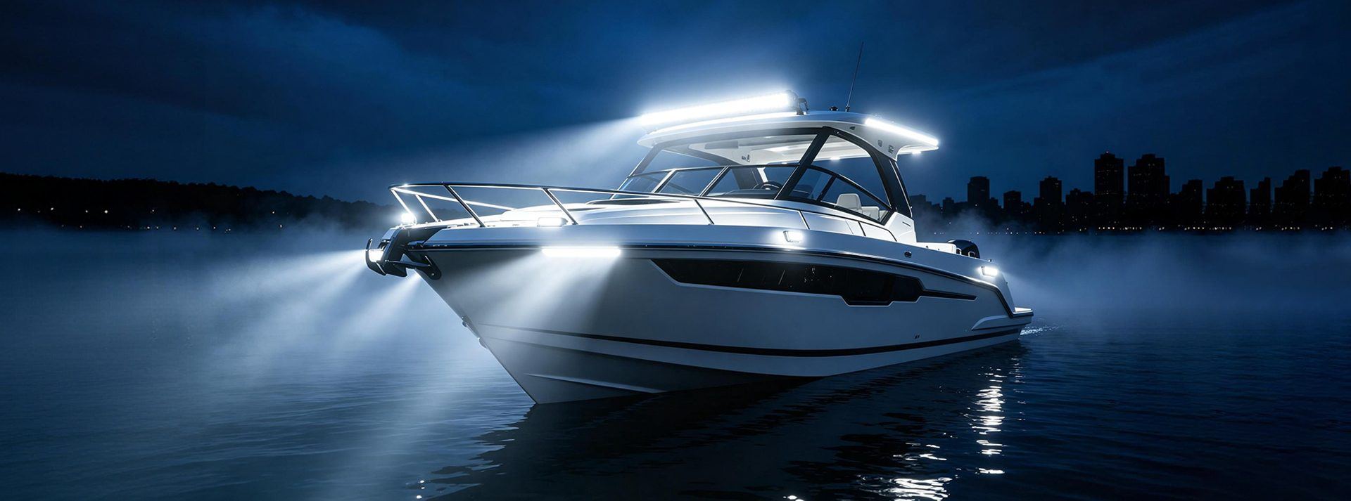Luxury white yacht with Aurora marine LED deck and underwater lights at night on calm water